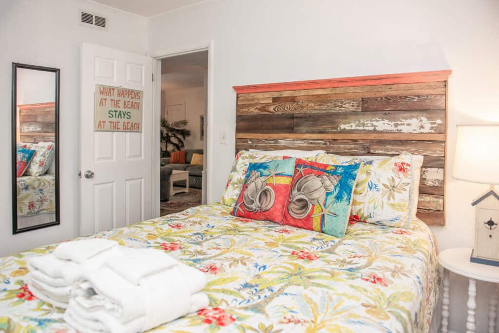 rustic worn headboard in bedroom with coastal bedding