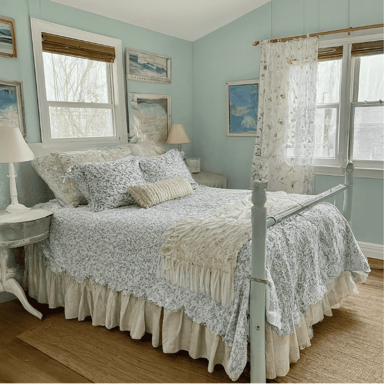 coastal cottage  bedroom with lace curtains and light blue walls